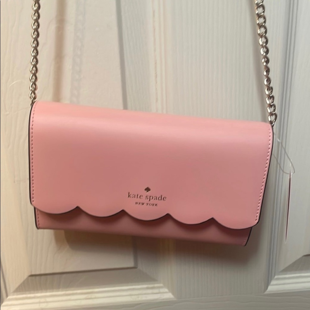 Kate Spade wallet on chain, in the color donut pink